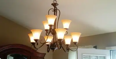 Classic ceiling chandelier installation with warm lighting in Stockton, CA