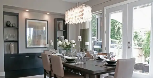 Elegant dining room chandelier installation above table in Stockton, CA