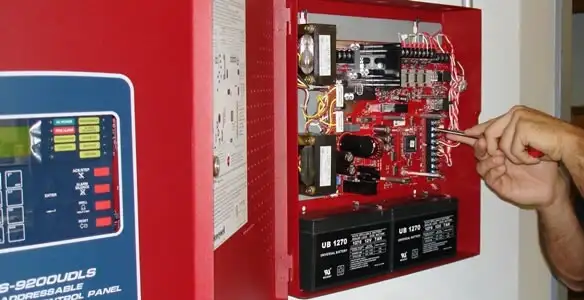 fire alarm installation service showing technician configuring fire alarm control panel in Stockton, CA