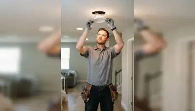 Stockton, CA electrician clipping trim rings into recessed ceiling light housings for a flush finish