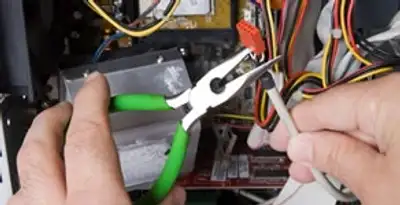 Licensed electrical contractor performing electrical repair with tools in Lodi, CA
