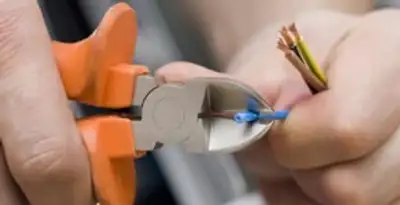 professional electrical services showing precise wire cutting by licensed electricians in Stockton, CA
