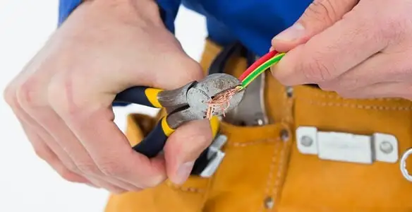 licensed electrician securing electrical wiring with professional tools during service work in Stockton, CA