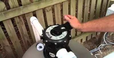 pool pumps service showing professional adjustment of pool pump control system in Stockton, CA