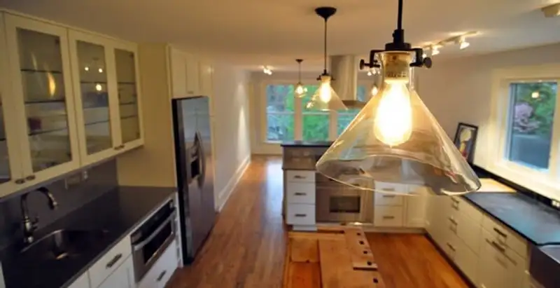 Residential electrician installing modern indoor light fixture in a home in Stockton, CA